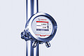 L-Rix inline refractometer mounted on a stainless steel pipe, displaying real-time refractive index and temperature measurements on its screen.