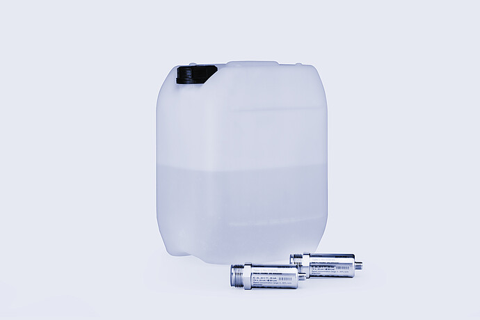 Two Anton Paar L-Rix 2100 inline refractometer sensors placed beside semi-transparent plastic container filled with liquid