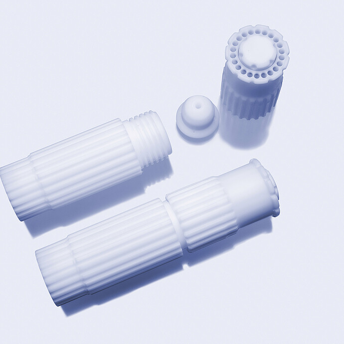 Microwave digestion vessel bodies with cap and plug components on a light background.