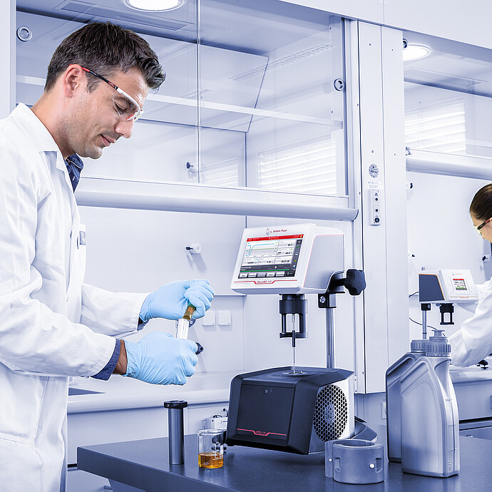 Three-quarter front view of the ViscoQC 300 rotational viscometer with the PTD 175 Peltier temperature device on a light blue background