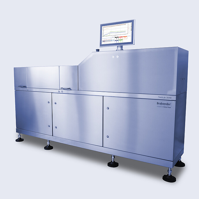 Angled view of Brabender TwinLab B-TSE-S-30-40 twin-screw extruder with closed housing and integrated touchscreen control unit on top