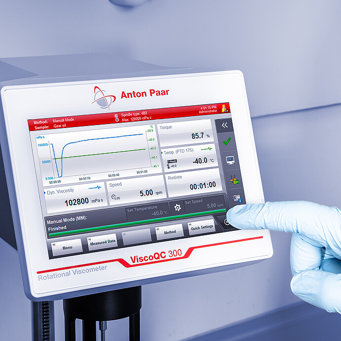 Gloved operator using the ViscoQC 300 touchscreen to run an automated ASTM D2983 low-temperature viscosity measurement.
