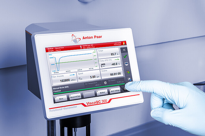 Gloved operator using the ViscoQC 300 touchscreen to run an automated ASTM D2983 low-temperature viscosity measurement.