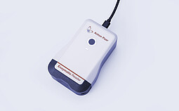 Anton Paar Enzymatic Reader digital ethanol meter with illuminated button and USB cable on light gray background.