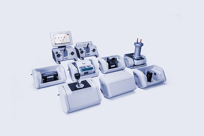 Anton Paar Lyza 7000 and Lyza 3000 FTIR spectrometers surrounded by interchangeable sampling modules and accessories.