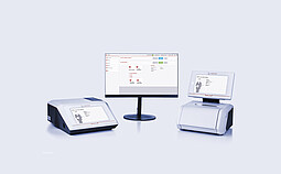 Cora 5001 Raman spectrometer and Lyza 7000 FTIR spectrometer connected to a central monitor displaying the Spectroscopy Suite spectral analysis software