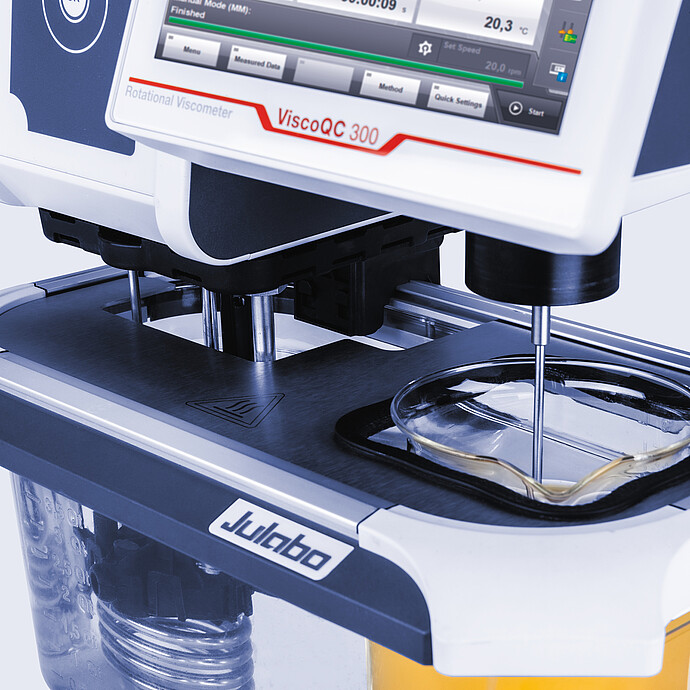 Close-up of ViscoQC 300 rotational viscometer with Julabo water bath and spindle immersed in glass beaker