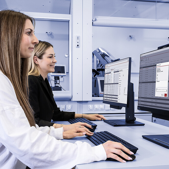 Two lab technicians use Anton Paar’s AP Connect software at desktop stations, with a DMA 4500 M density meter visible in the background.