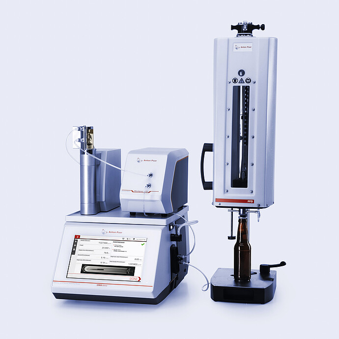 Anton Paar DMA 5000 M with Alcolyzer Beer ME and filling module connected to PFD measuring device holding a brown glass bottle