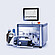 Brabender AbsorptoMeter with closed measuring chamber and integrated display showing torque curve, connected via tubing to dosing unit and reagent bottle on lab bench