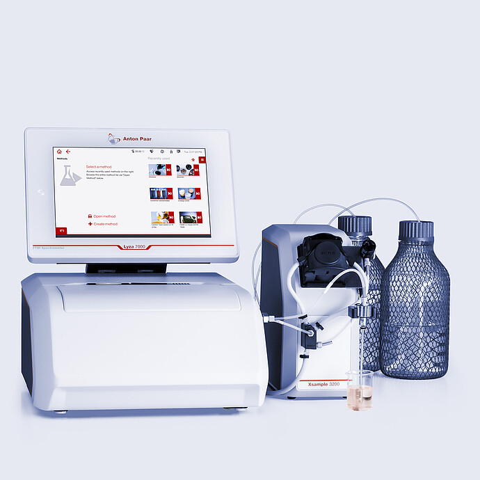 Anton Paar Lyza 7000 FTIR spectrometer connected to an Xsample 3200 autosampler, with tubing, two bottles, and two sample vials.