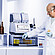 Technician handling beer samples beside Anton Paar RTD Measurement System with DMA 5002, HazeQC ME, Alcolyzer ME, and Xsample 5100.