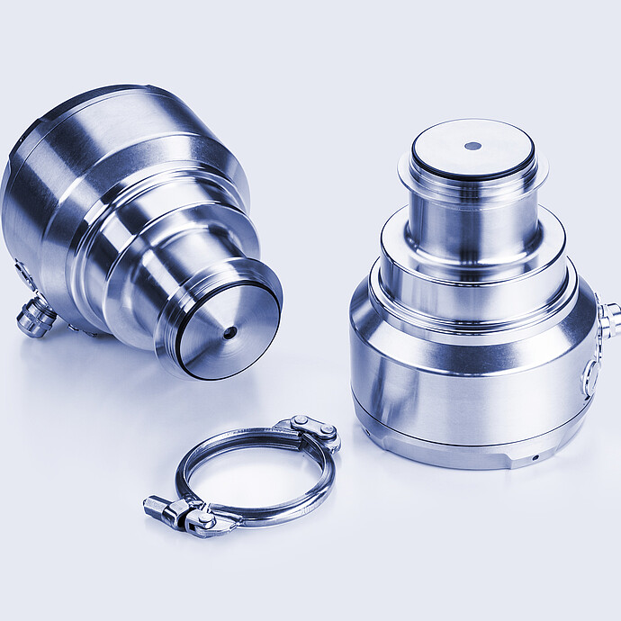 L-Rix inline refractometer with a stainless steel housing, shown in two positions along with a tri-clamp connector for hygienic installation